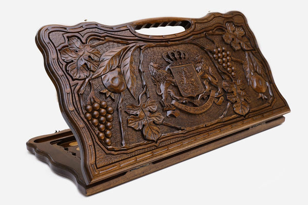 Carved beechwood backgammon board with the Georgian coat of arms and a carry handle, propped open