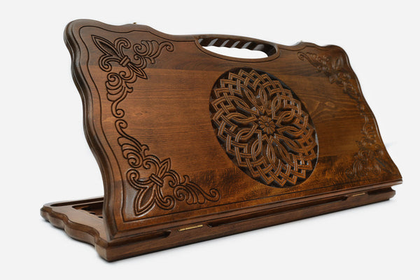 Carved beechwood backgammon board with an ornate carved ornament and a carry handle, propped open