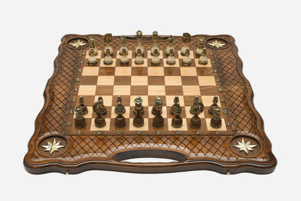 Luxury carved chess set with four inlaid brass stars, lattice borders and ornate bronze pieces set up for play