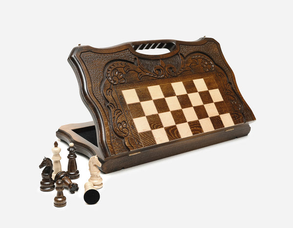 Carved walnut chess set standing open, showing the playing field, floral ornament border and built-in carry handle