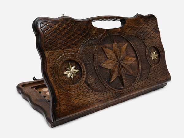 Carved beechwood backgammon board with an octagonal star and bronze details, propped open
