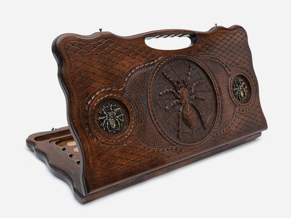 Carved beechwood backgammon board with a spider on its web and bronze details, propped open