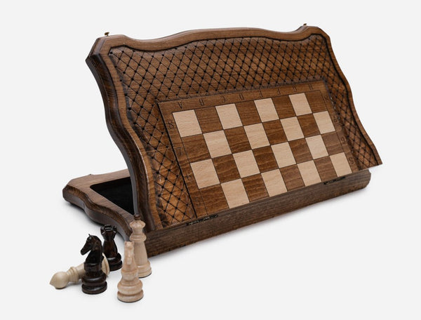 Folding wooden chess board propped upright showing the open storage compartment for the pieces