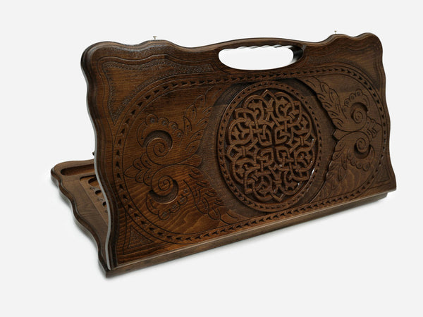 Carved Armenian backgammon board with a woven interlaced ornament and a cut-out carry handle, propped open