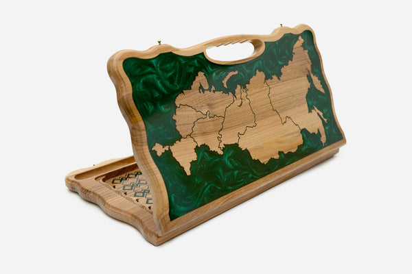 Folding backgammon board with a wooden map of Russia set in swirling green epoxy, standing open with a carved carry handle