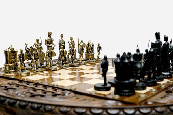 Close-up of the Crusader chess pieces, a gilded brass army facing a black army of medieval knights, kings and castle rooks
