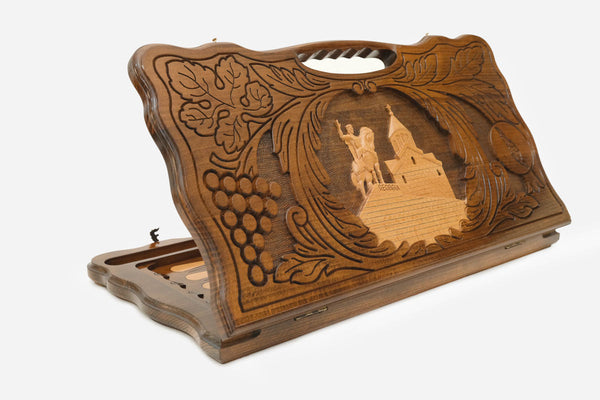 Carved Georgian backgammon board with King Vakhtang Gorgasali in a wreath of grapevines, cut-out carry handle, propped open