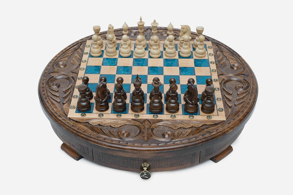 Round chess set with storage, turquoise-blue epoxy squares and turned wooden pieces set up for play