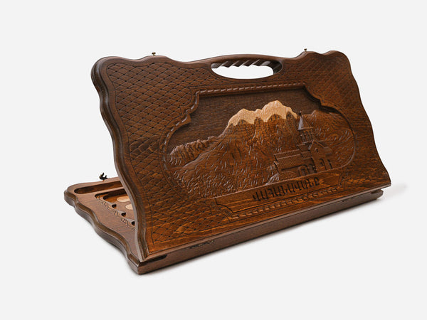 Carved Armenian backgammon board with the Vahanavank monastery among mountains and a cut-out carry handle, propped open