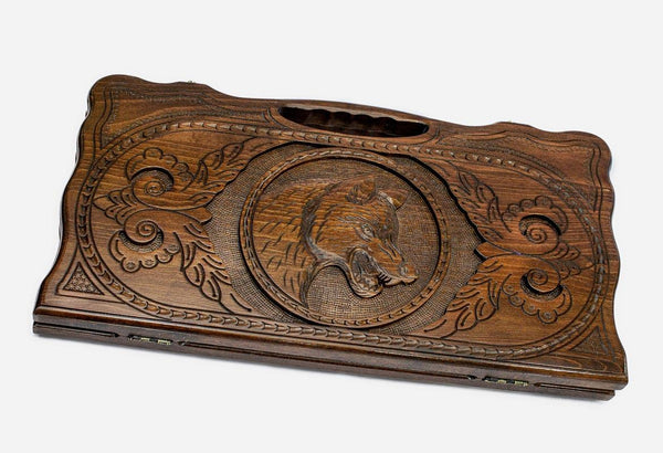 Carved beechwood backgammon board with a prowling wolf and carry handle, propped open
