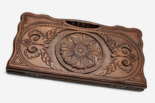 Carved beechwood backgammon board with a floral ornament, propped open