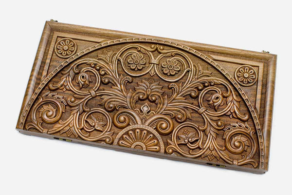 Master-carved walnut backgammon board with an intricate world of scrollwork, propped open