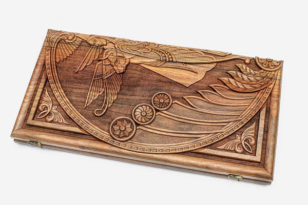 Master-carved walnut backgammon board with a winged cherub, propped open