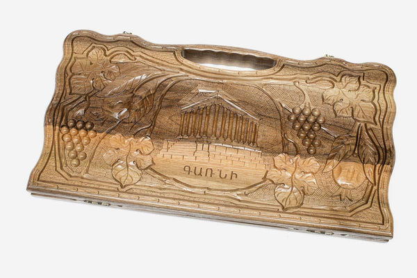 Carved walnut backgammon board with the Temple of Garni, pomegranates and grapes, propped open