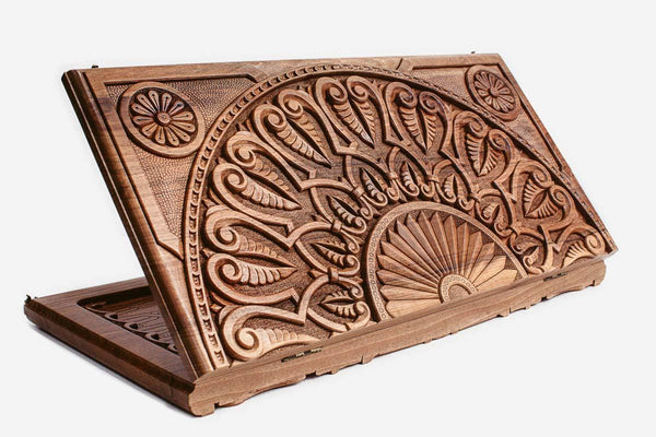 Master-carved walnut backgammon board with a grand fan ornament and a carry handle, propped open