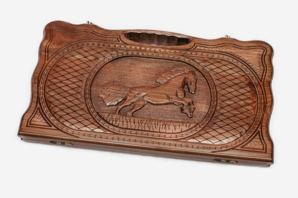 Carved walnut backgammon board with a horse at its center and a carry handle, propped open