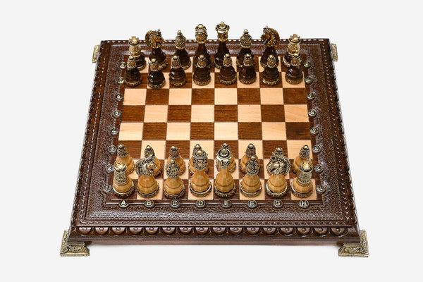 Luxury chess set with figural bronze pieces on a carved board