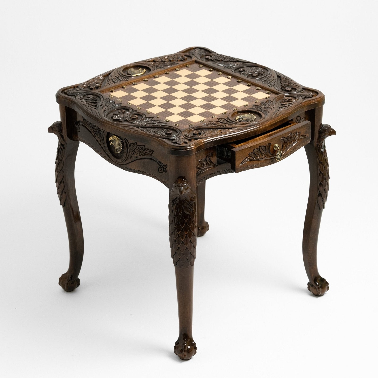 Gold eagle accent on the carved chess table apron