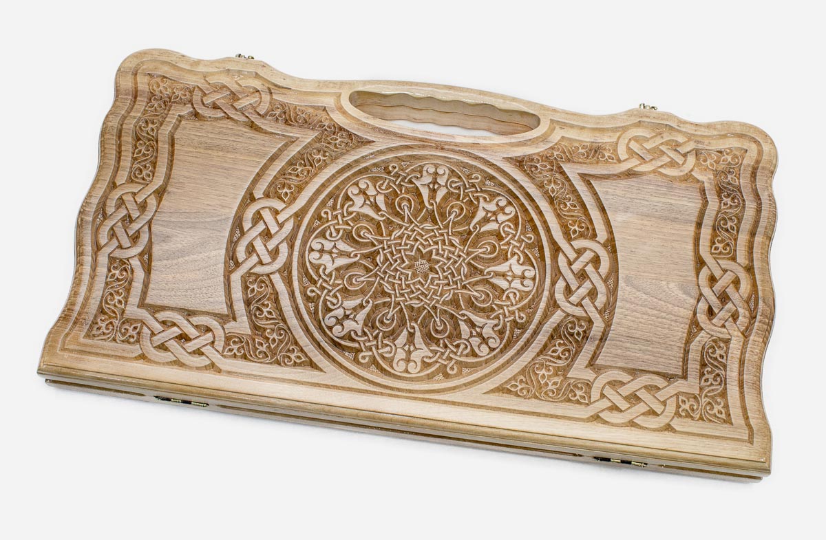 Carved walnut backgammon board with interlaced ornament edge to edge, shown flat