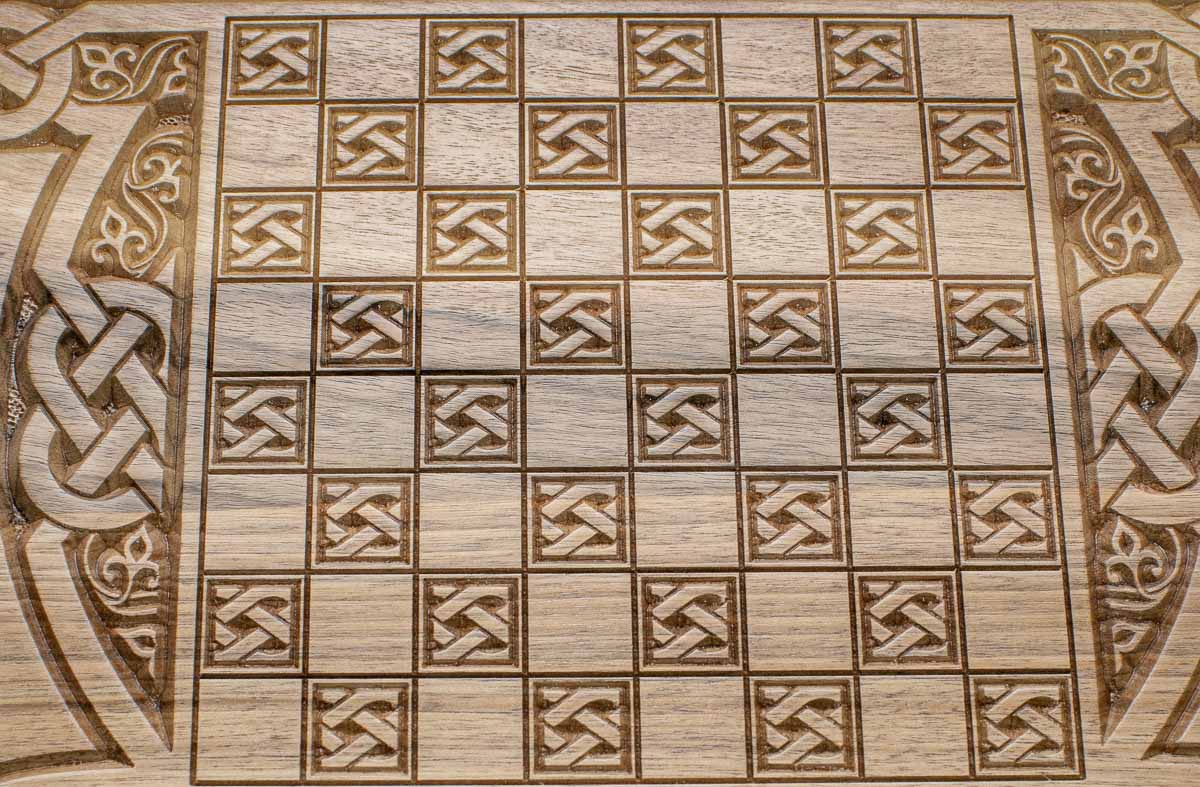 The backgammon board opened to show the wooden playing surface