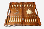 The backgammon board opened to show the wooden playing surface