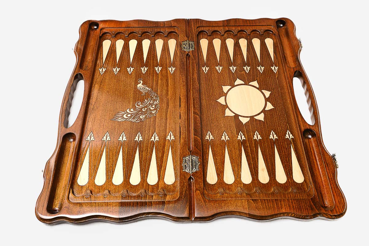 The backgammon board opened to show the wooden playing surface