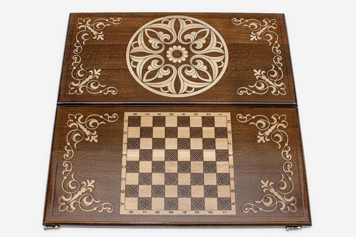 Close-up of the carved Armenian ornament lifted pale against the wood