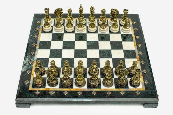 Green and cream marble chess set with hand-cast bronze pieces arranged for play and brass coordinate markers