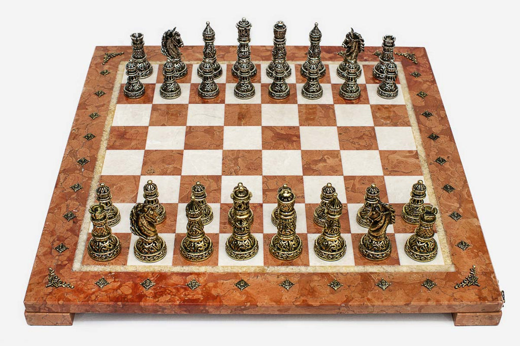 Coral and cream marble chess set with hand-cast bronze pieces arranged for play and brass coordinate markers