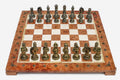 Coral and cream marble chess set with hand-cast bronze pieces arranged for play and brass coordinate markers