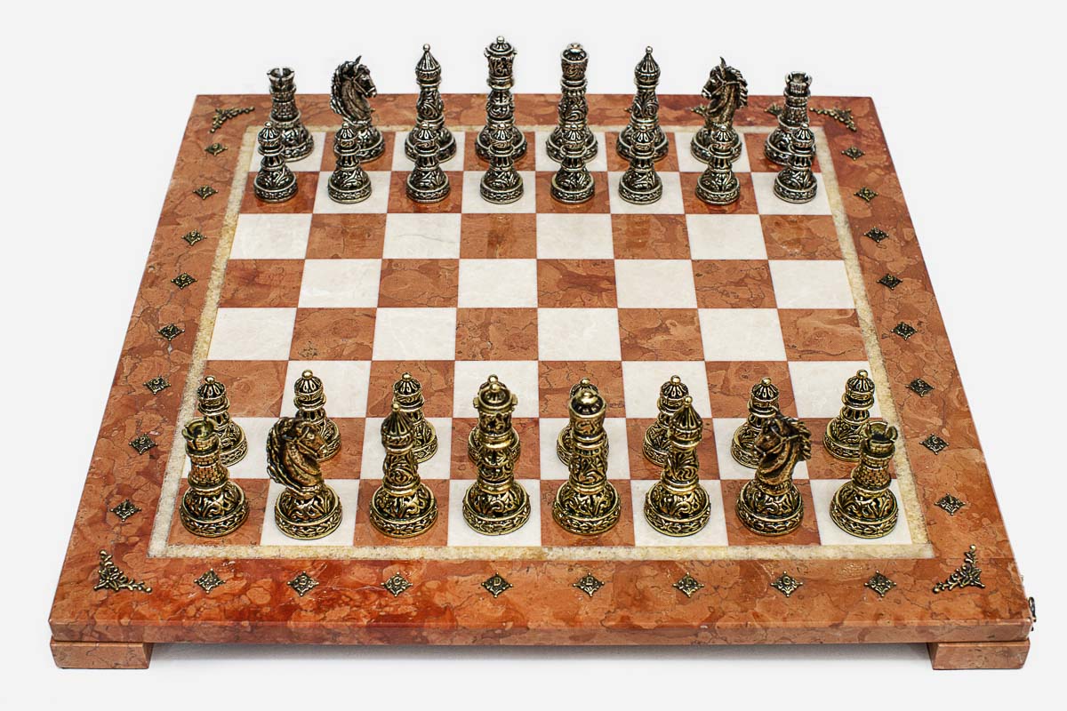 Coral and cream marble chess set with hand-cast bronze pieces arranged for play and brass coordinate markers