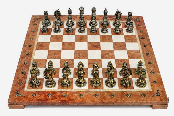 Coral and cream marble chess set with hand-cast bronze pieces arranged for play and brass coordinate markers