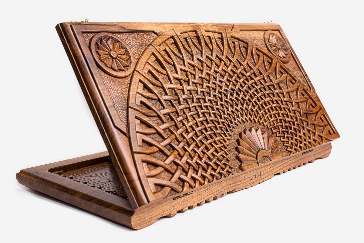 Master-carved walnut backgammon board with a woven infinity fan design, propped open