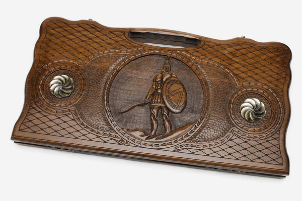 Carved beechwood backgammon board with a Spartan warrior and bronze ornaments, propped open