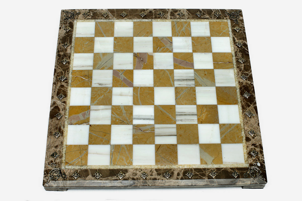 Golden and white marble chess set with bronze pieces on display