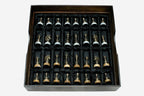 Cast bronze chess pieces on the golden and white marble board