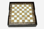 Golden and white marble chess board with hand-cast bronze pieces