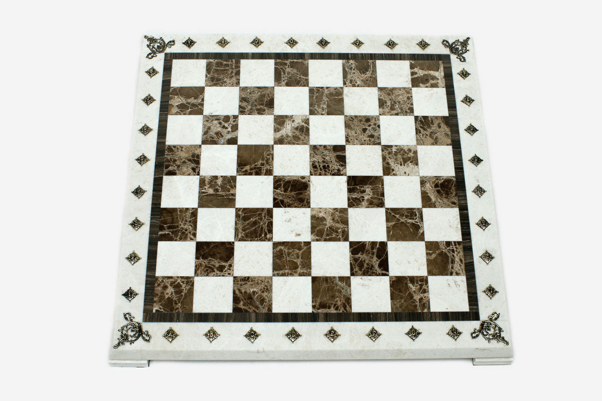 Top-down view of the empty cream and brown marble chess board with brass coordinate markers