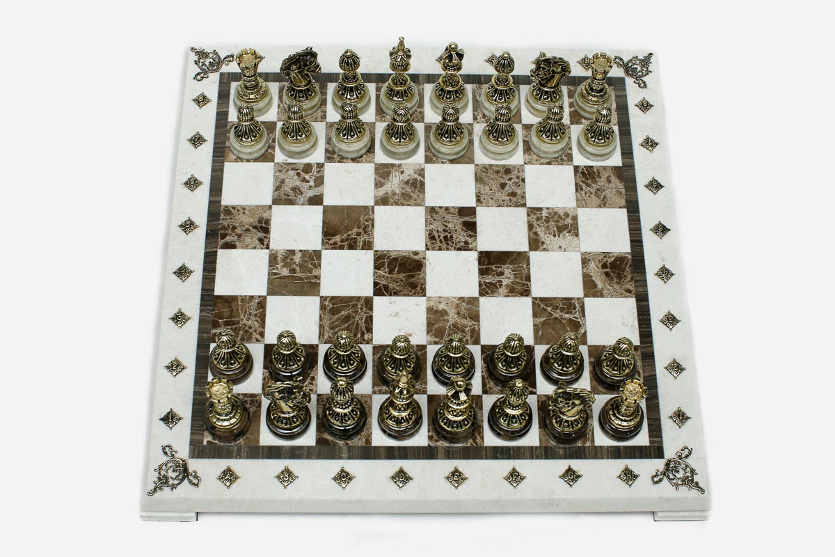 Cream and brown marble chess set with hand-cast bronze pieces arranged for play and brass coordinate markers