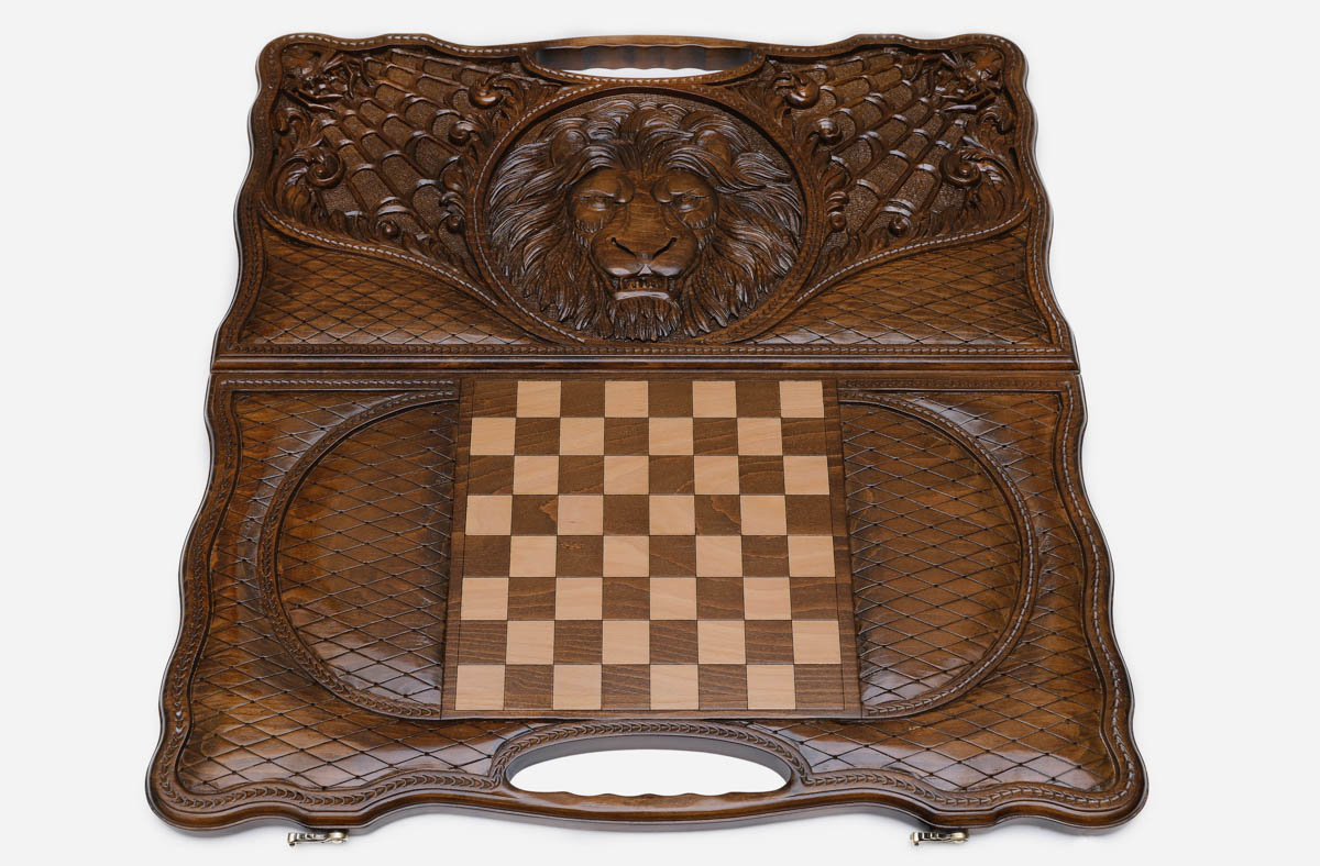 Angled view of the lion and spider carved backgammon board
