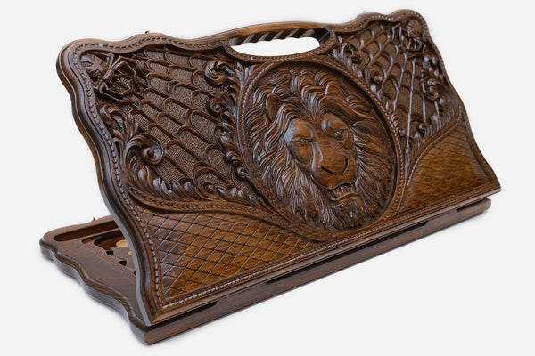 Carved beechwood backgammon board with a lion and spider webs, with a carry handle, propped open
