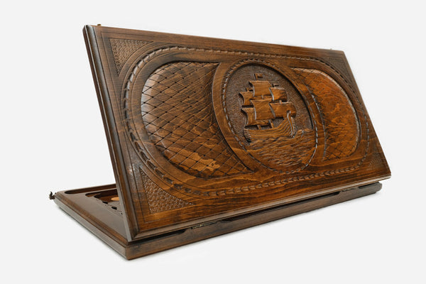 Wooden backgammon set hand carved with a sailing ship riding the swell
