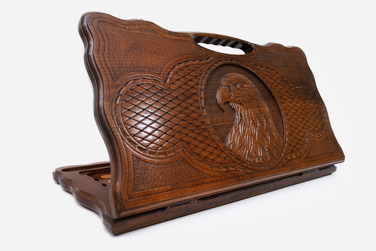 Carved beechwood backgammon board with an eagle's head and a carry handle, propped open