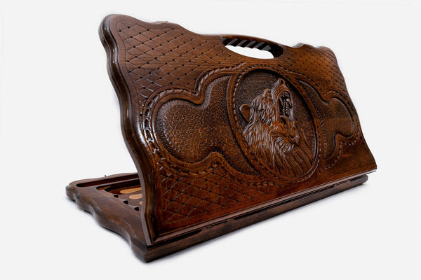 Carved beechwood backgammon board with a powerful bear and a carry handle, propped open