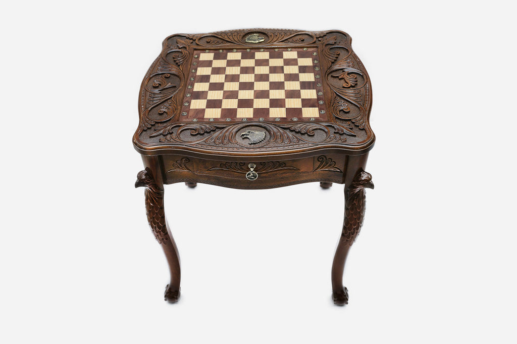 Hand-carved eagle chess table with bronze army, angled view