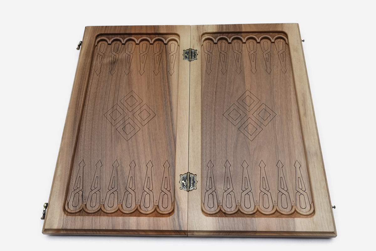 Close-up of the deep-carved walnut relief on the Khent board