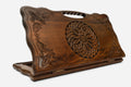 Carved beechwood backgammon board with an ornate carved ornament and a carry handle, propped open