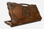 Carved beechwood backgammon board with an ornate carved ornament and a carry handle, propped open