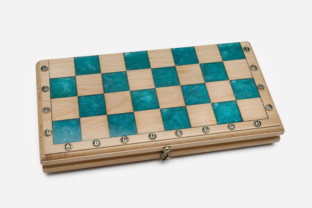 The teal epoxy chess set shown from an angle
