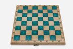 Overhead view of the empty teal epoxy chessboard with brass coordinate markers